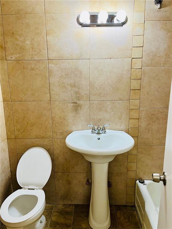 2330 Voorhies Avenue, Unit 1C Brooklyn, NY 11235 - Photo 9 of 10 a bathroom with a sink a toilet