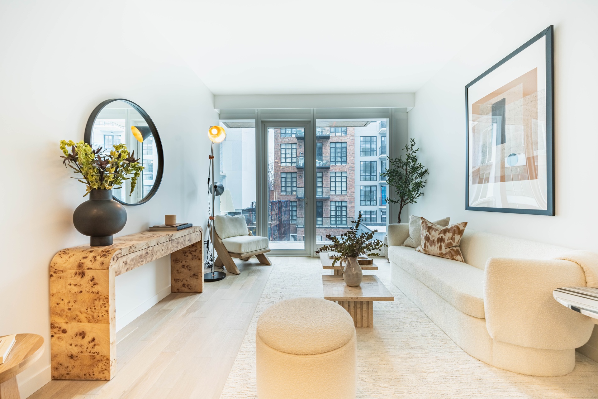37-34 33rd Street, Unit 6B Queens, NY 11101 - Photo 1 of 11 a living room with furniture a chandelier and a large window