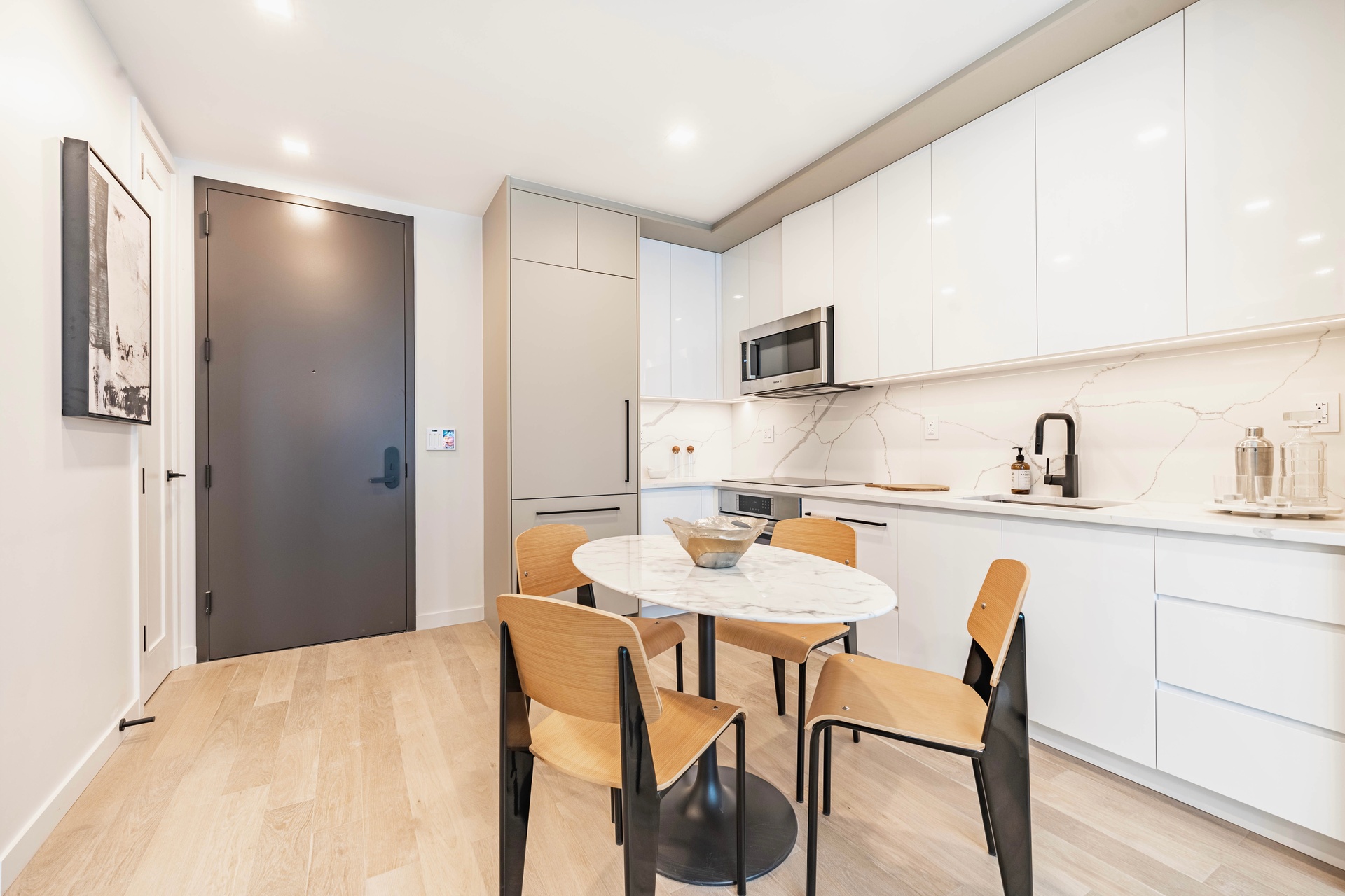 37-34 33rd Street, Unit 6B Queens, NY 11101 - Photo 3 of 11 a kitchen with stainless steel appliances granite countertop a sink and a refrigerator