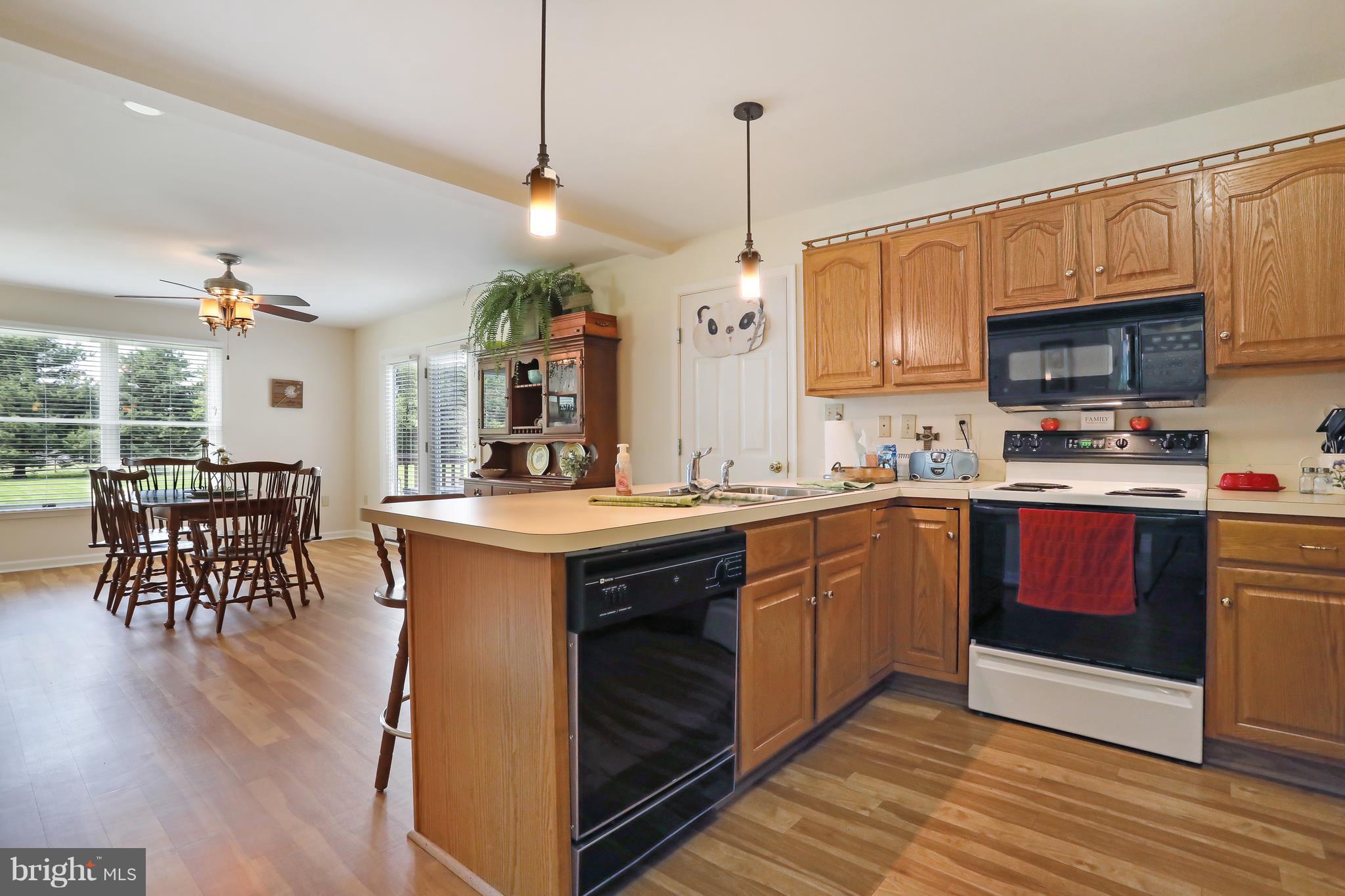 13816 Big Pool Road Clear Spring, MD 21722 - Photo 4 of 24 a kitchen with stainless steel appliances granite countertop a sink a stove and a wooden floors