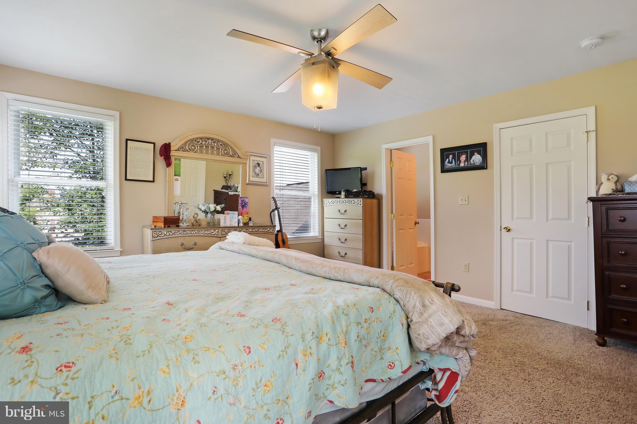 13816 Big Pool Road Clear Spring, MD 21722 - Photo 9 of 24 a bedroom with a bed and a chandelier