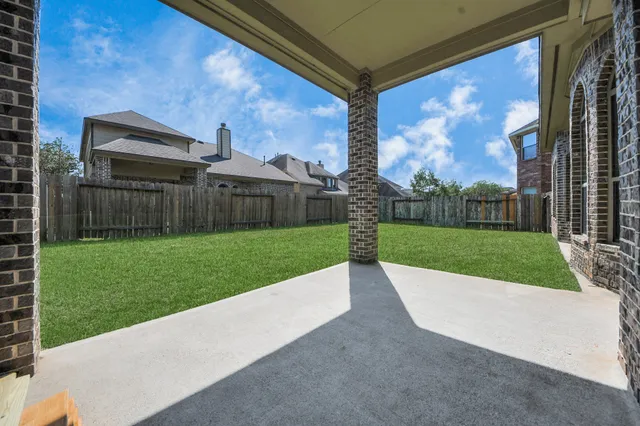 a view of a house with a yard and sitting area