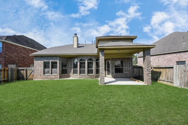 a view of a house with a yard and sitting area