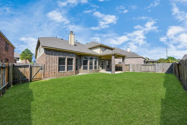 a view of a backyard with wooden fence