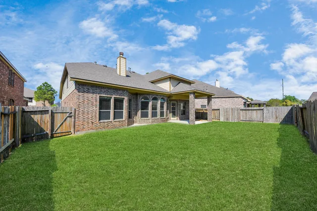 a view of a backyard with wooden fence