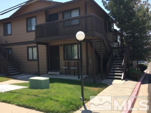 1400 Selmi Drive Reno, NV 89512 - Photo 1 of 1 a backyard of a house with table and chairs