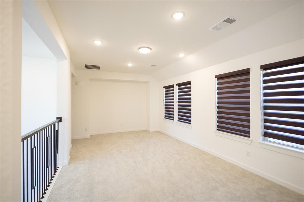 3017 Andorra Road McKinney, TX 75071 - Photo 29 of 40 Recessed ceiling lighting, multiple windows with blinds, light-colored carpeting, and a black wrought iron railing