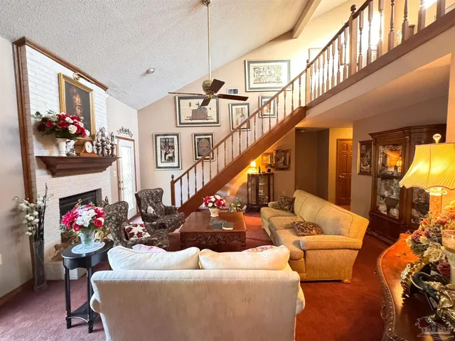 a living room with furniture and flowers