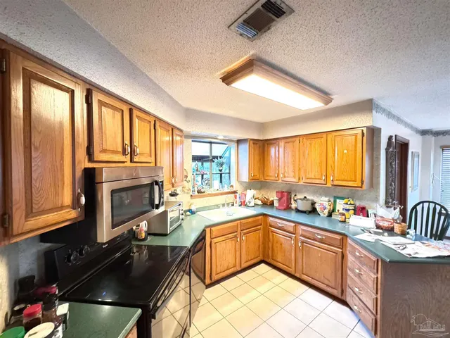 a kitchen with a sink appliances cabinets and a counter top space