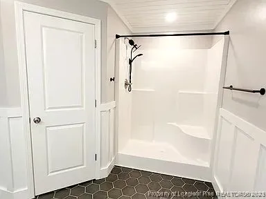 a bathroom with a glass shower door