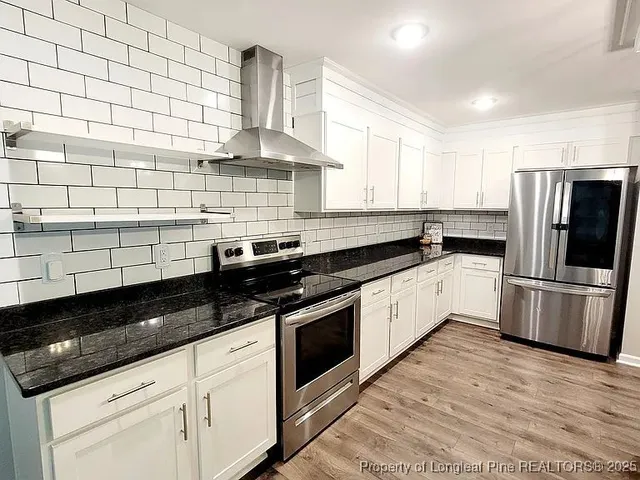 a kitchen with a sink a stove and refrigerator
