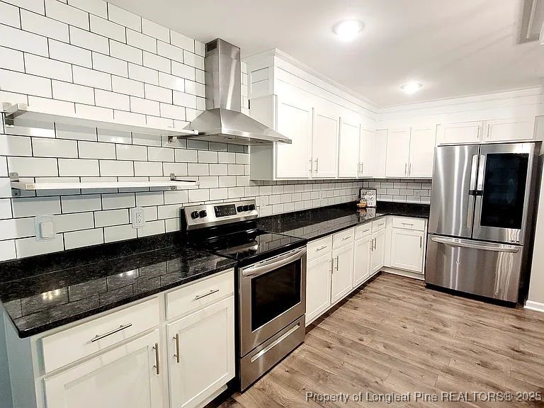 83 Kotata Avenue Bunnlevel, NC 28323 - Photo 7 of 17 a kitchen with a sink a stove and refrigerator