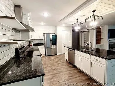 a kitchen with stainless steel appliances kitchen island granite countertop a sink counter space cabinets and stainless steel appliances