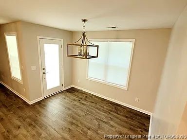 83 Kotata Avenue Bunnlevel, NC 28323 - Photo 10 of 17 a view of empty room with wooden floor and fan