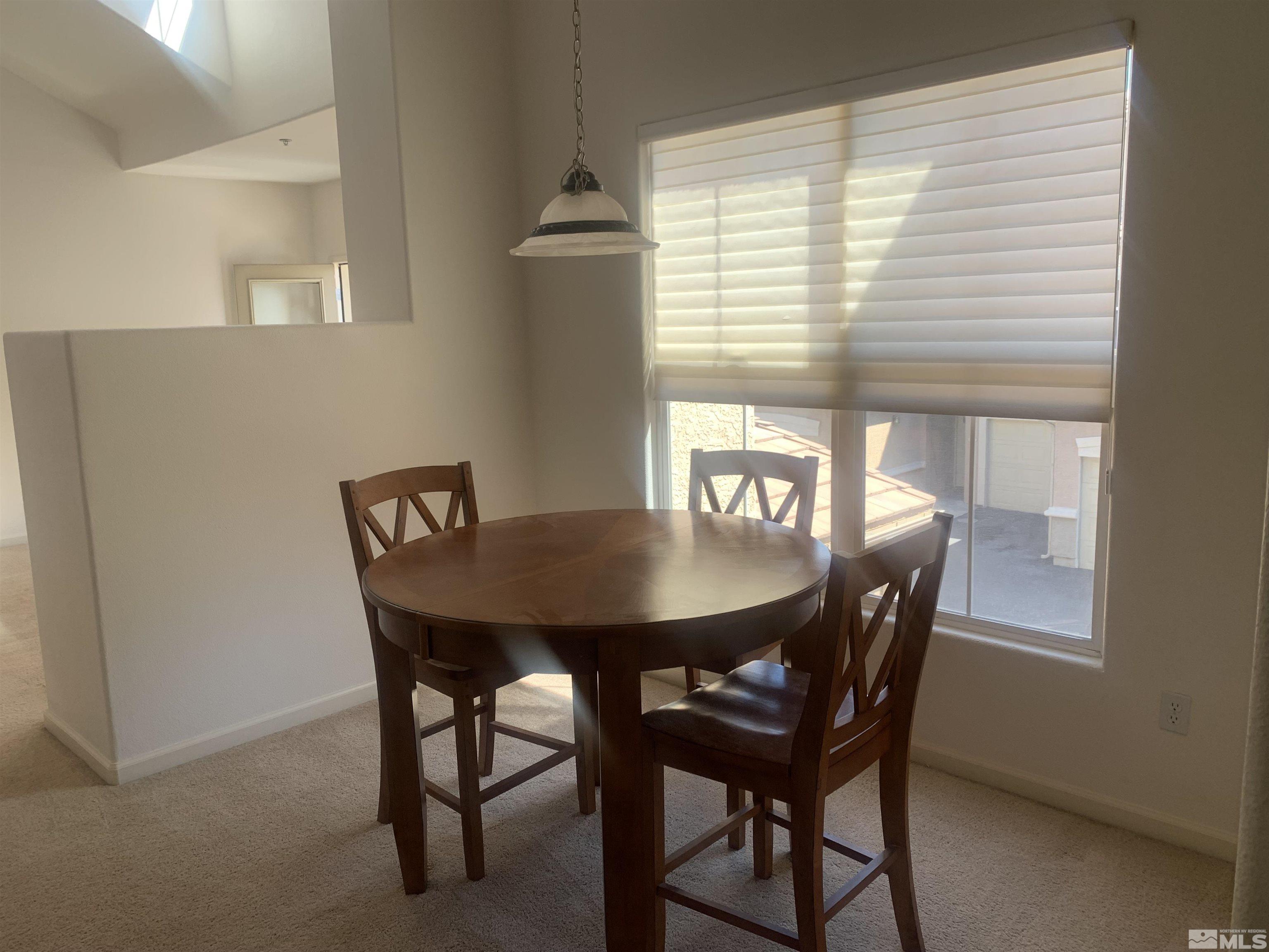 1325 South Meadows Parkway, Unit 422 Reno, NV 89521 - Photo 4 of 10 a view of a dining room with furniture and window