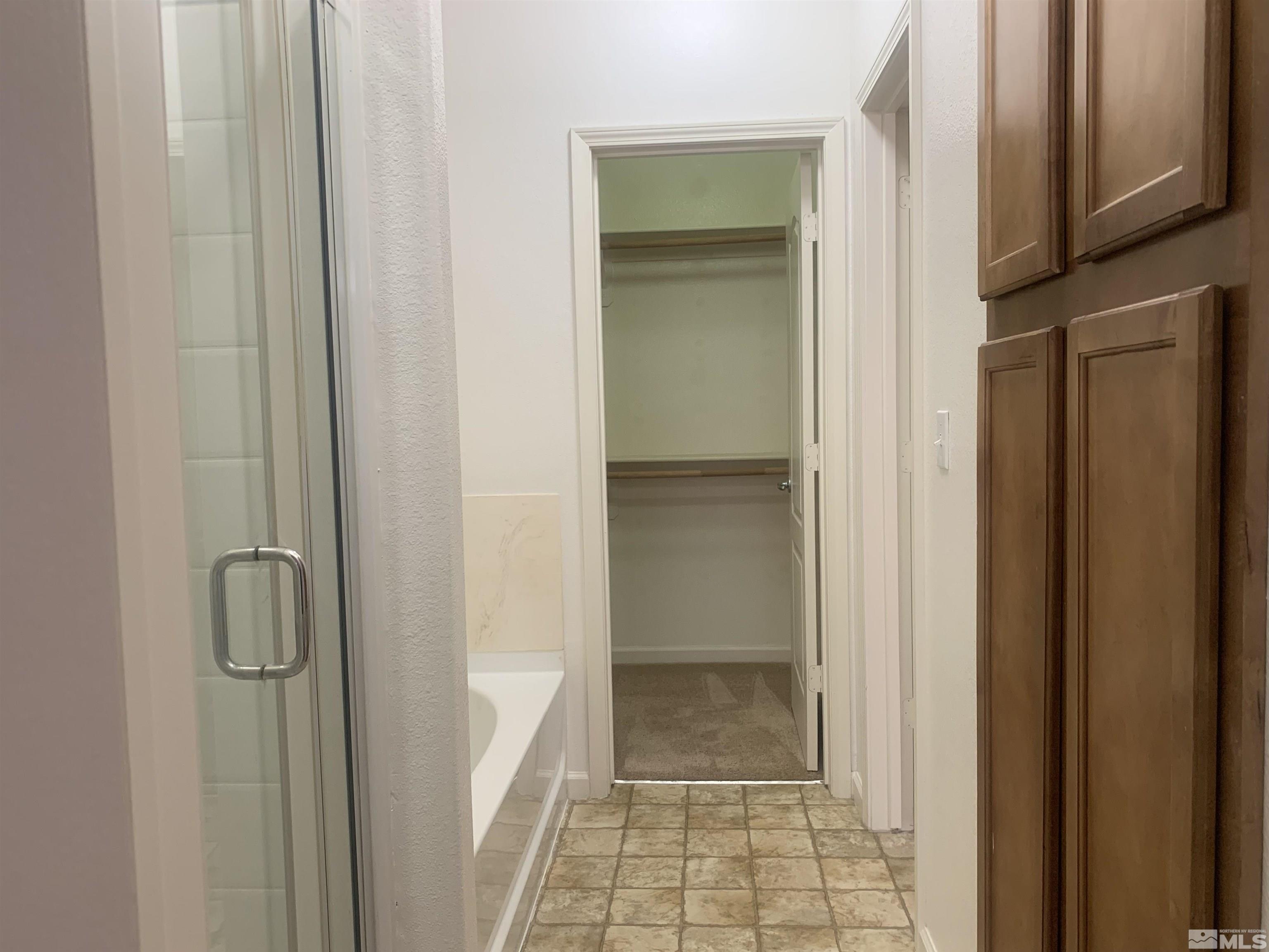 1325 South Meadows Parkway, Unit 422 Reno, NV 89521 - Photo 8 of 10 a bathroom with a glass shower door