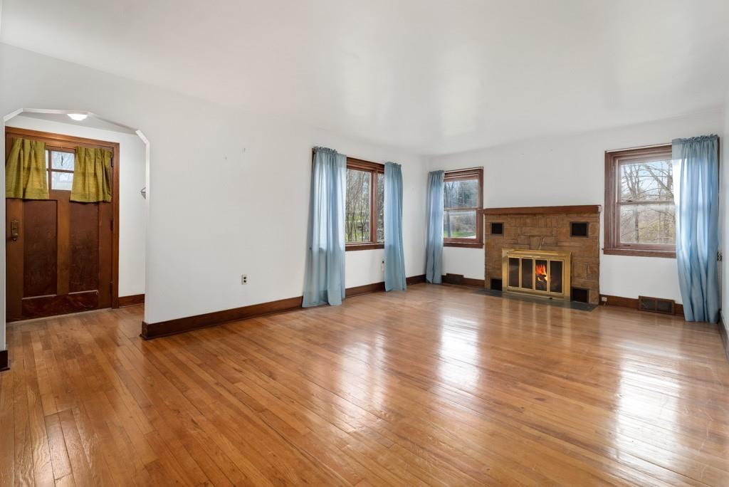 1038 Pittsburgh Road Valencia, PA 16059 - Photo 14 of 25 an empty room with wooden floor fireplace and windows