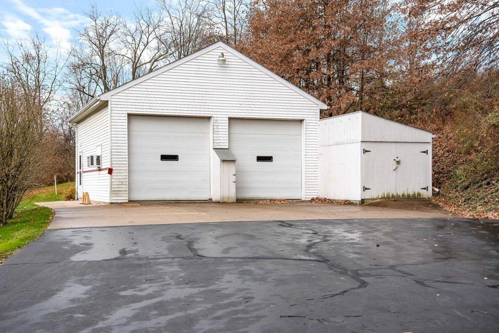 1038 Pittsburgh Road Valencia, PA 16059 - Photo 3 of 25 a front view of a house with a yard and garage