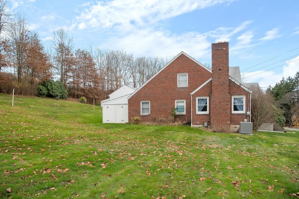 1038 Pittsburgh Road Valencia, PA 16059 - Photo 23 of 25 a house that is sitting in the grass with large trees