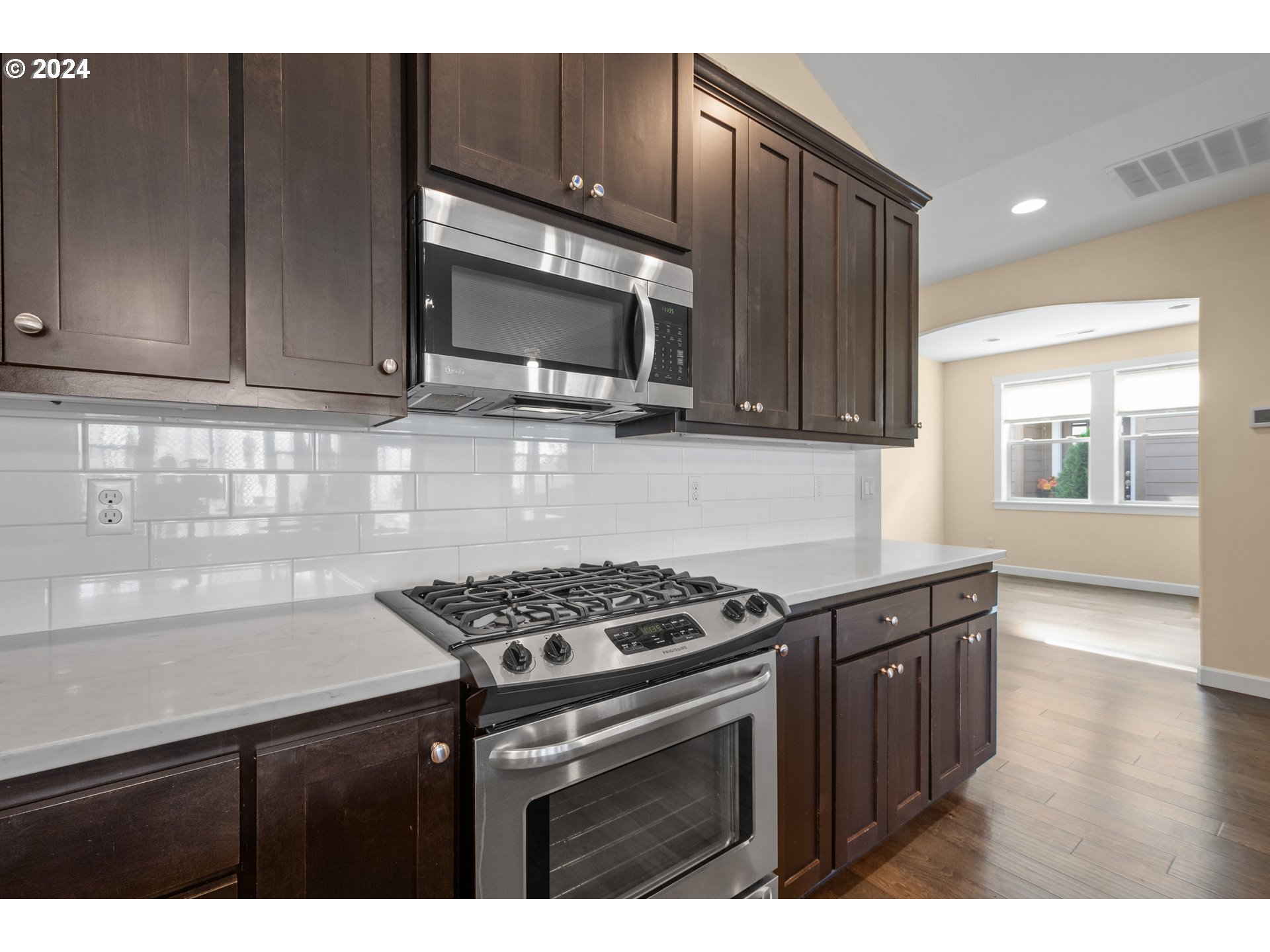 17632 Northeast 17th Avenue Ridgefield, WA 98642 - Photo 11 of 30 a kitchen with granite countertop a stove and a microwave
