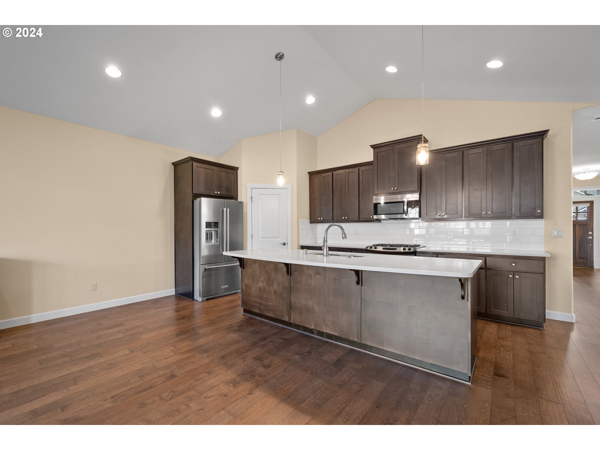 17632 Northeast 17th Avenue Ridgefield, WA 98642 - Photo 8 of 30 a large kitchen with stainless steel appliances kitchen island granite countertop a large counter top and oven