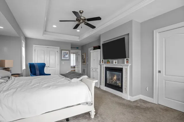 a spacious bedroom with a large bed and a fireplace