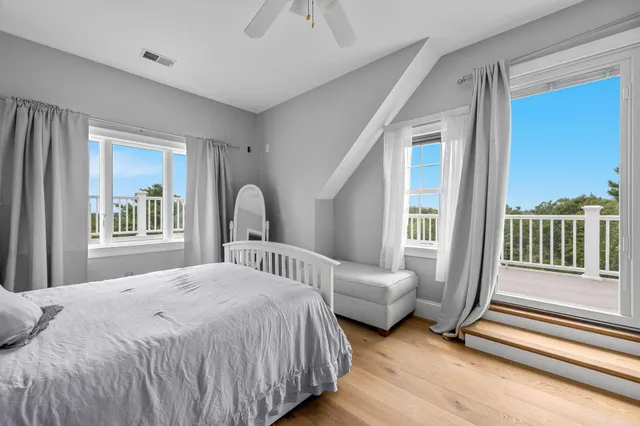 a bedroom with a bed next to a large window