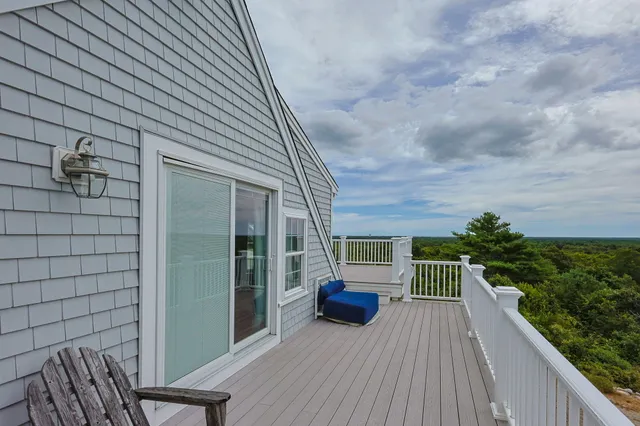 a balcony with furniture and potted plants