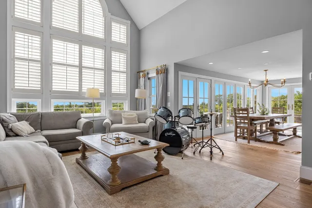 a living room with furniture and large windows