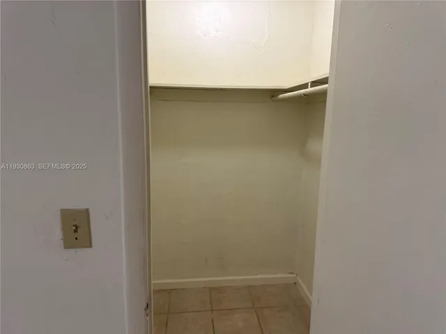 a room with a refrigerator and a stove