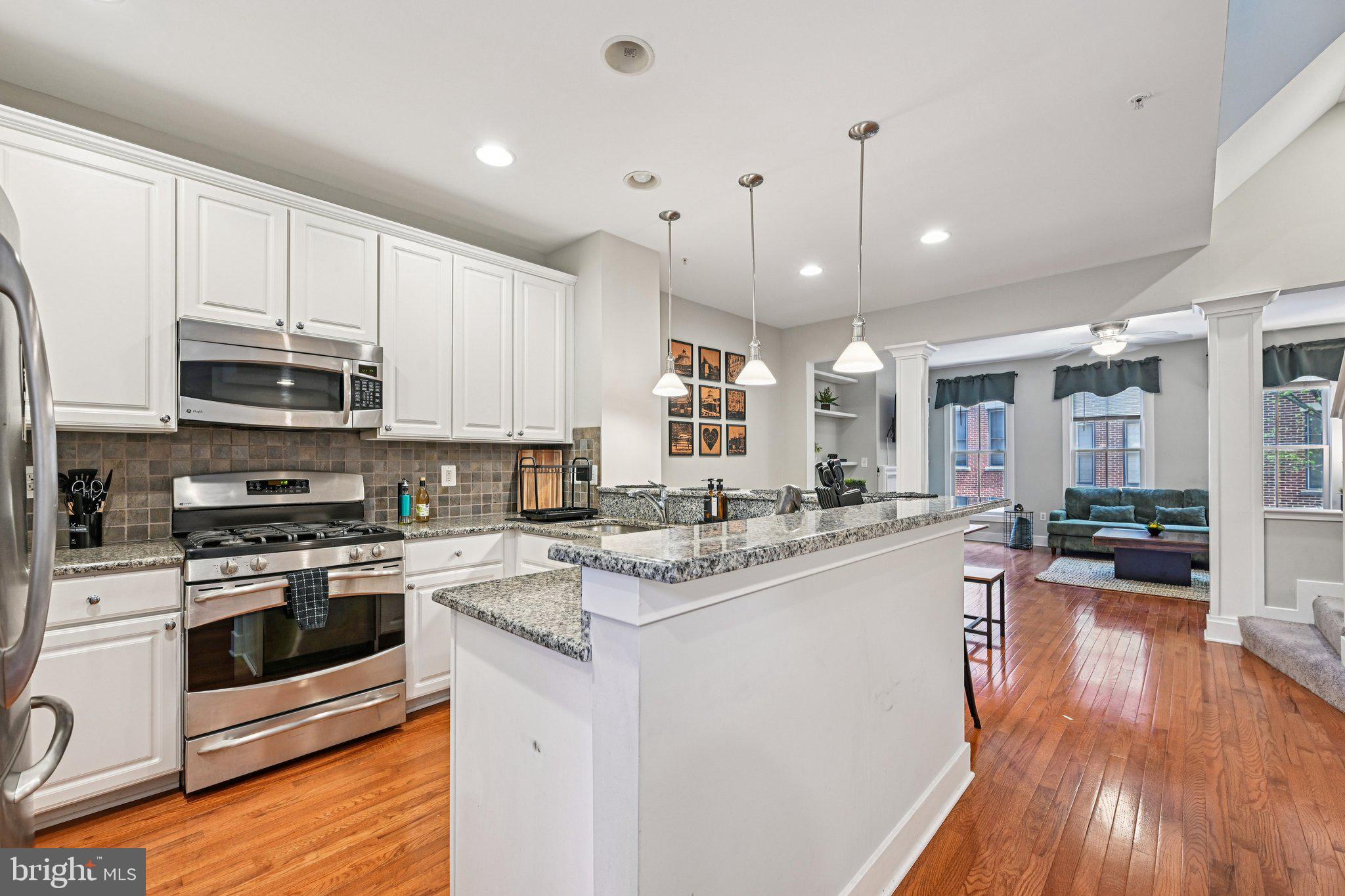 24 South Regester Street Baltimore, MD 21231 - Photo 3 of 44 a kitchen with stainless steel appliances granite countertop a sink a stove top oven a counter space and cabinets