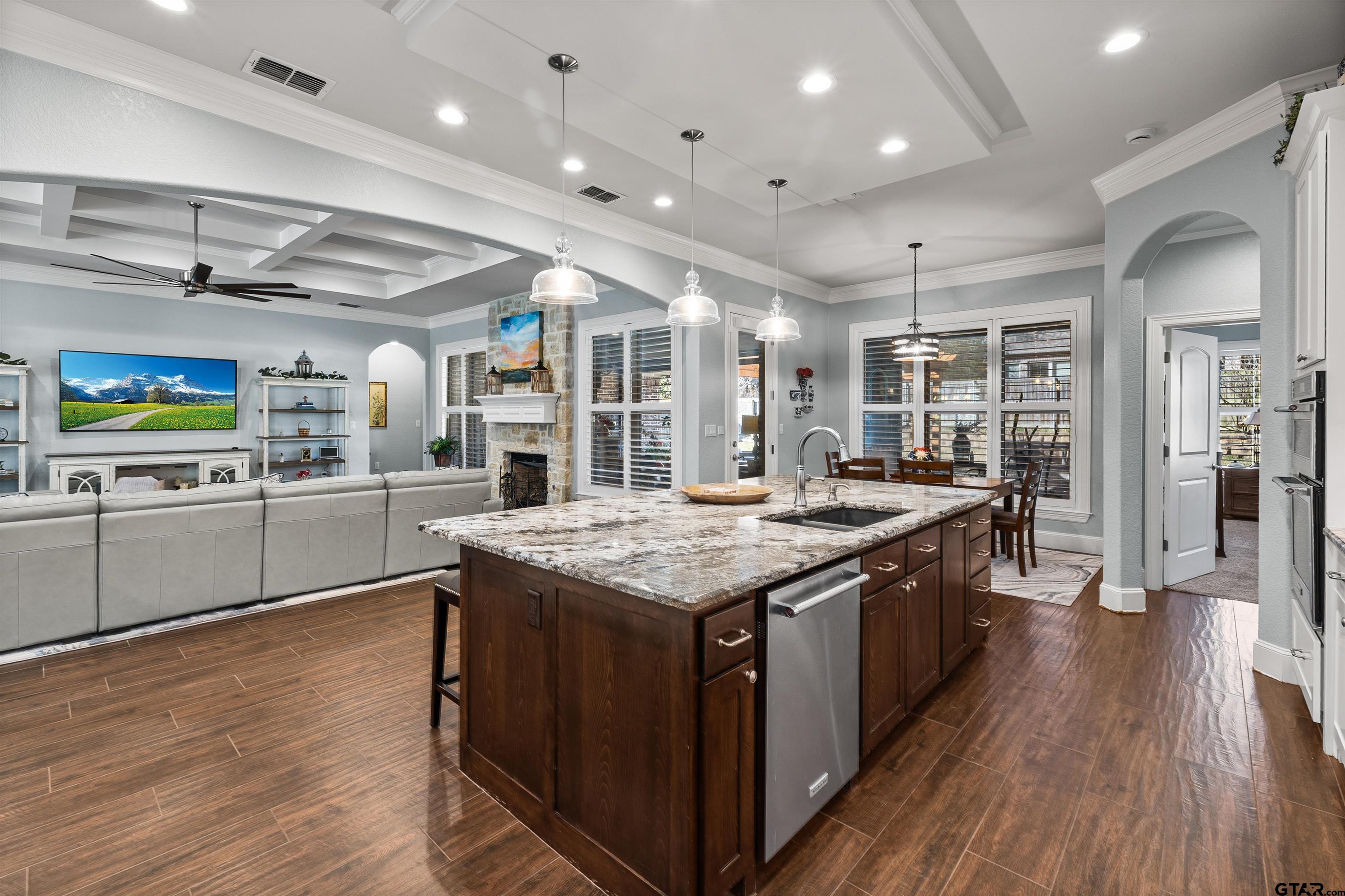 1111 Cambridge Bend Tyler, TX 75703 - Photo 11 of 42 a kitchen with stainless steel appliances granite countertop lots of counter top space and wooden floor