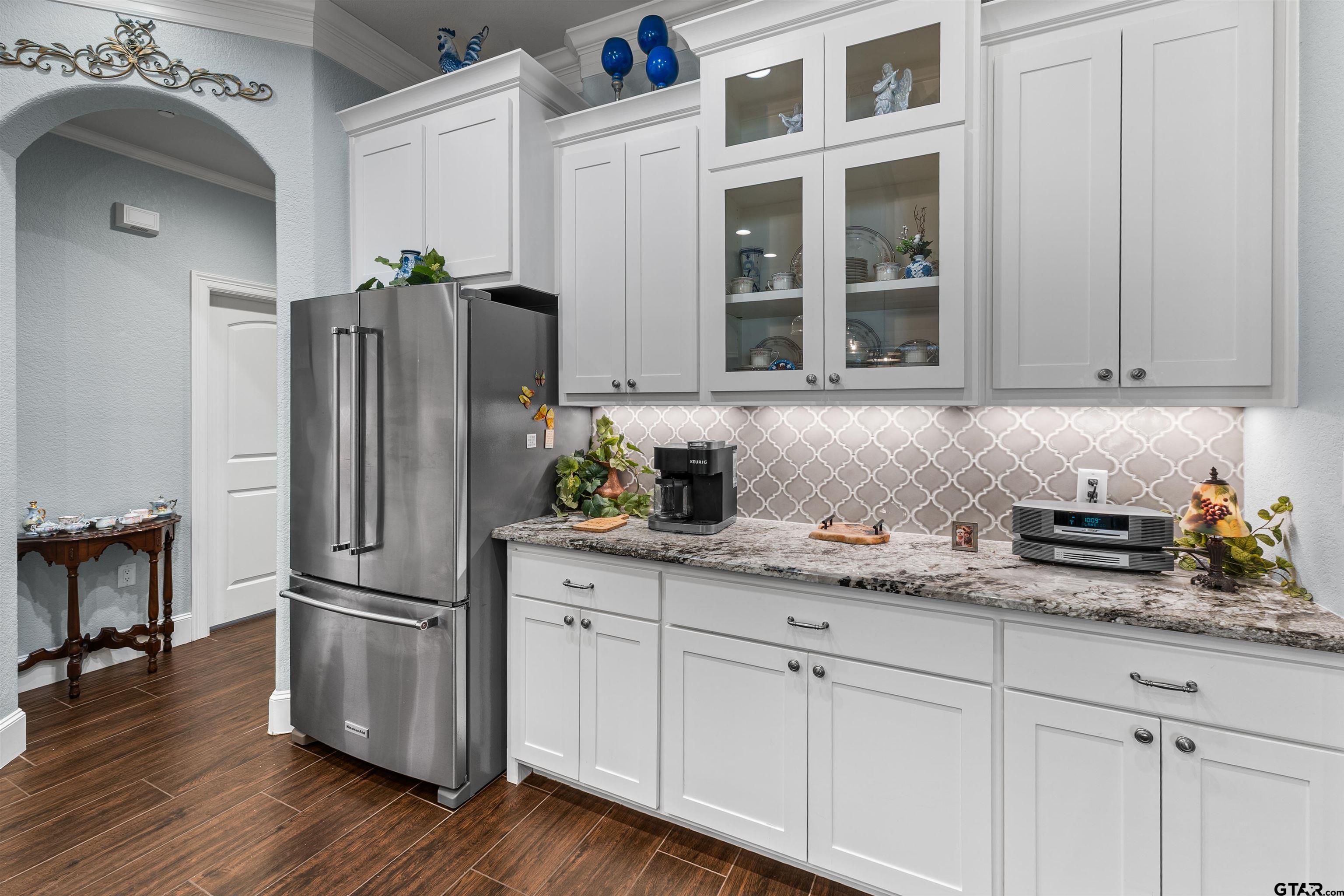 1111 Cambridge Bend Tyler, TX 75703 - Photo 13 of 42 a kitchen with stainless steel appliances granite countertop a refrigerator and a stove
