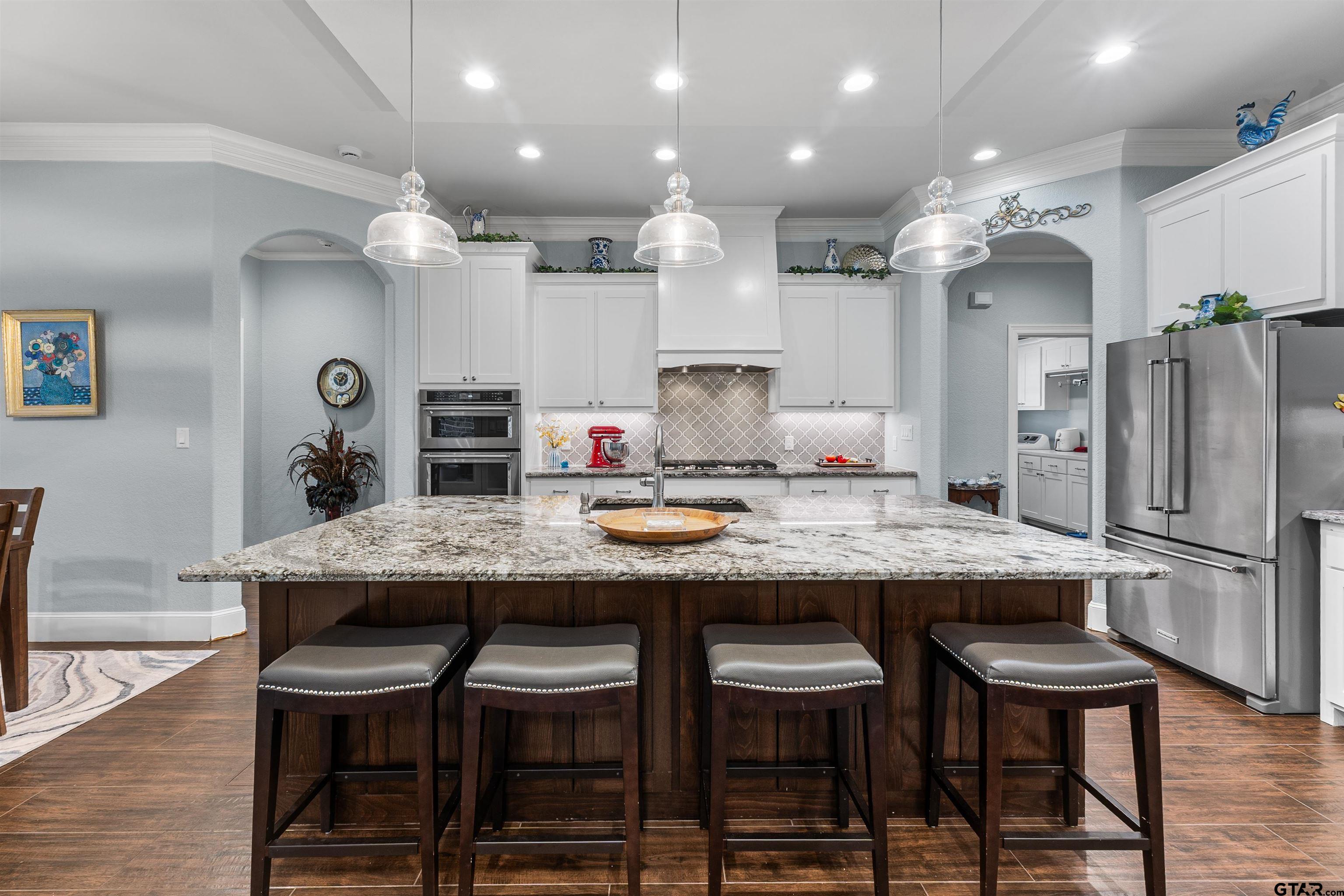 1111 Cambridge Bend Tyler, TX 75703 - Photo 15 of 42 a kitchen with granite countertop and chairs in it