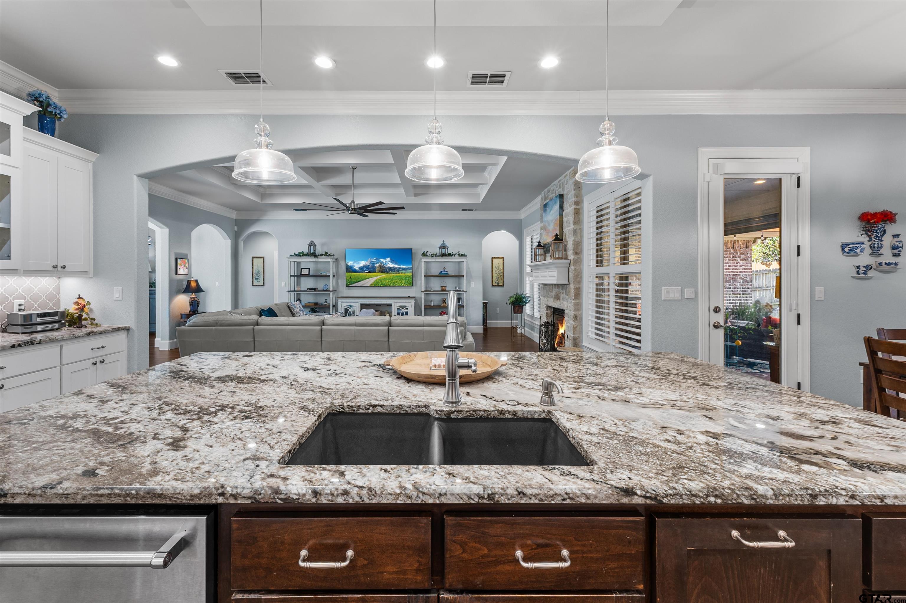 1111 Cambridge Bend Tyler, TX 75703 - Photo 16 of 42 a kitchen with stainless steel appliances granite countertop a sink a stove and a wooden cabinets