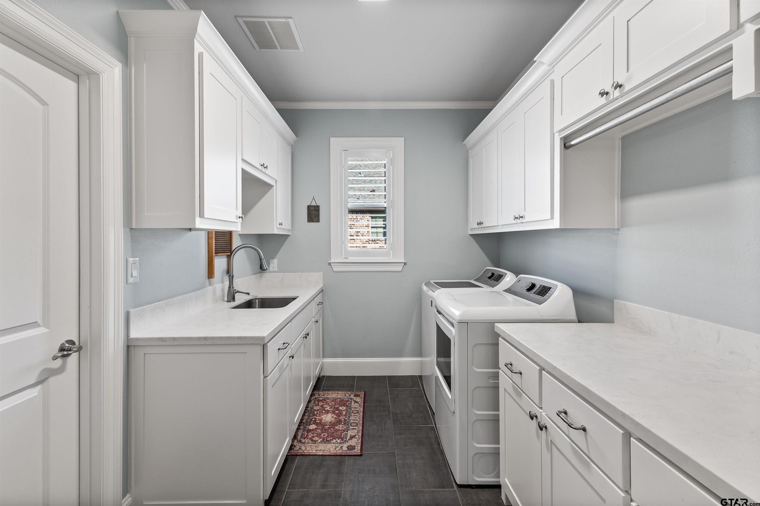 1111 Cambridge Bend Tyler, TX 75703 - Photo 18 of 42 a utility room with sink dryer and washer