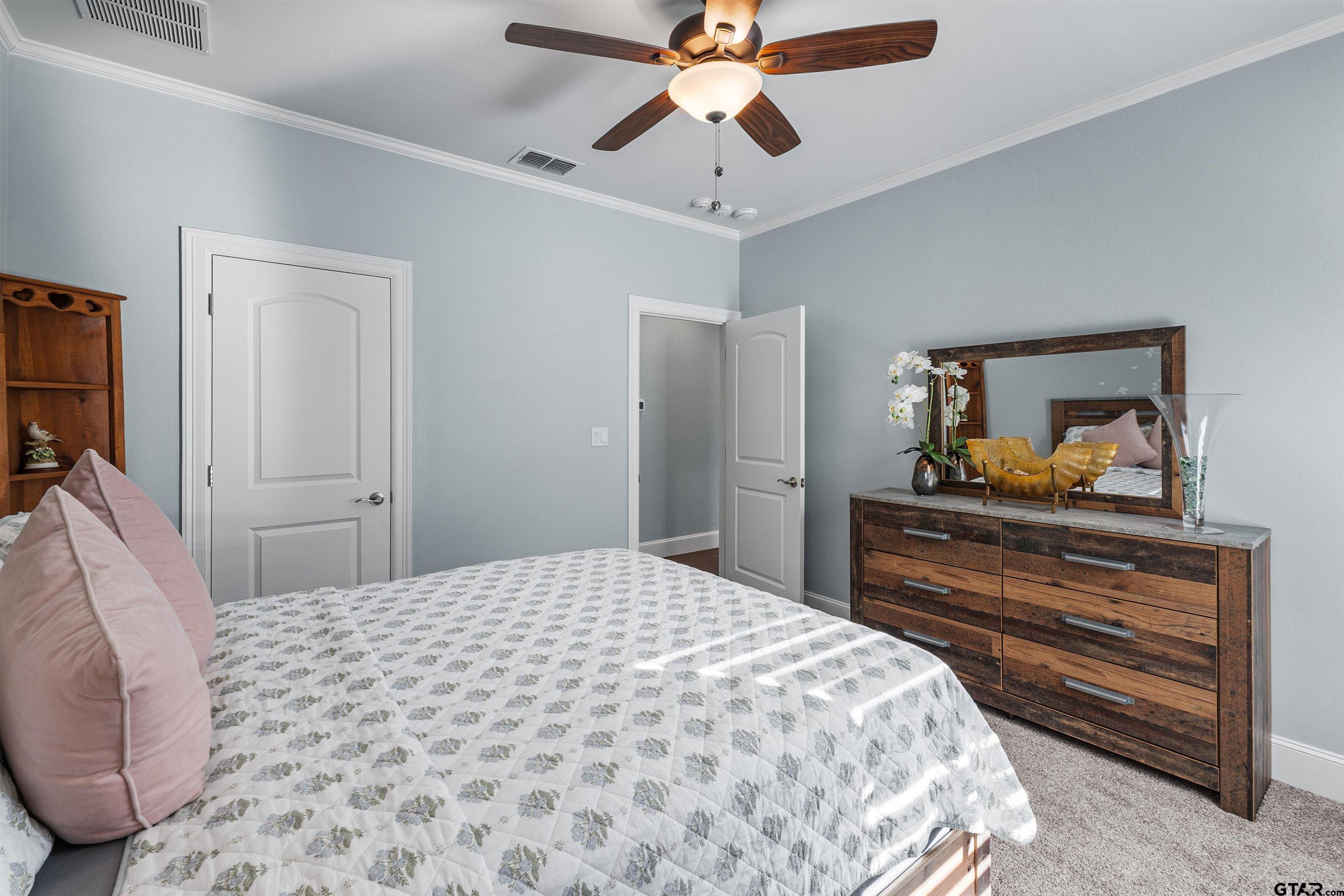 1111 Cambridge Bend Tyler, TX 75703 - Photo 21 of 42 a bedroom with a bed and a dresser