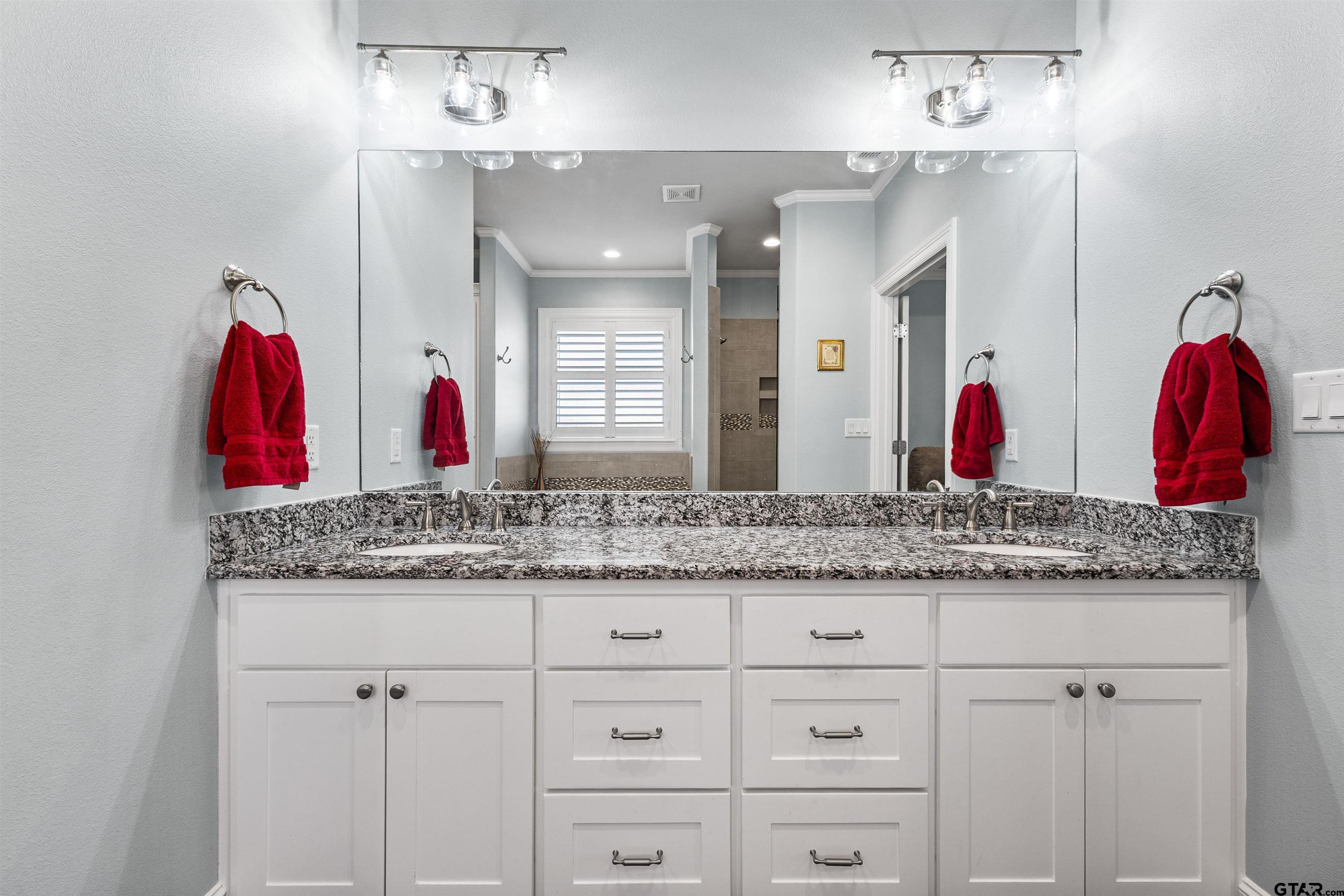 1111 Cambridge Bend Tyler, TX 75703 - Photo 30 of 42 a bathroom with a granite countertop sink and a mirror