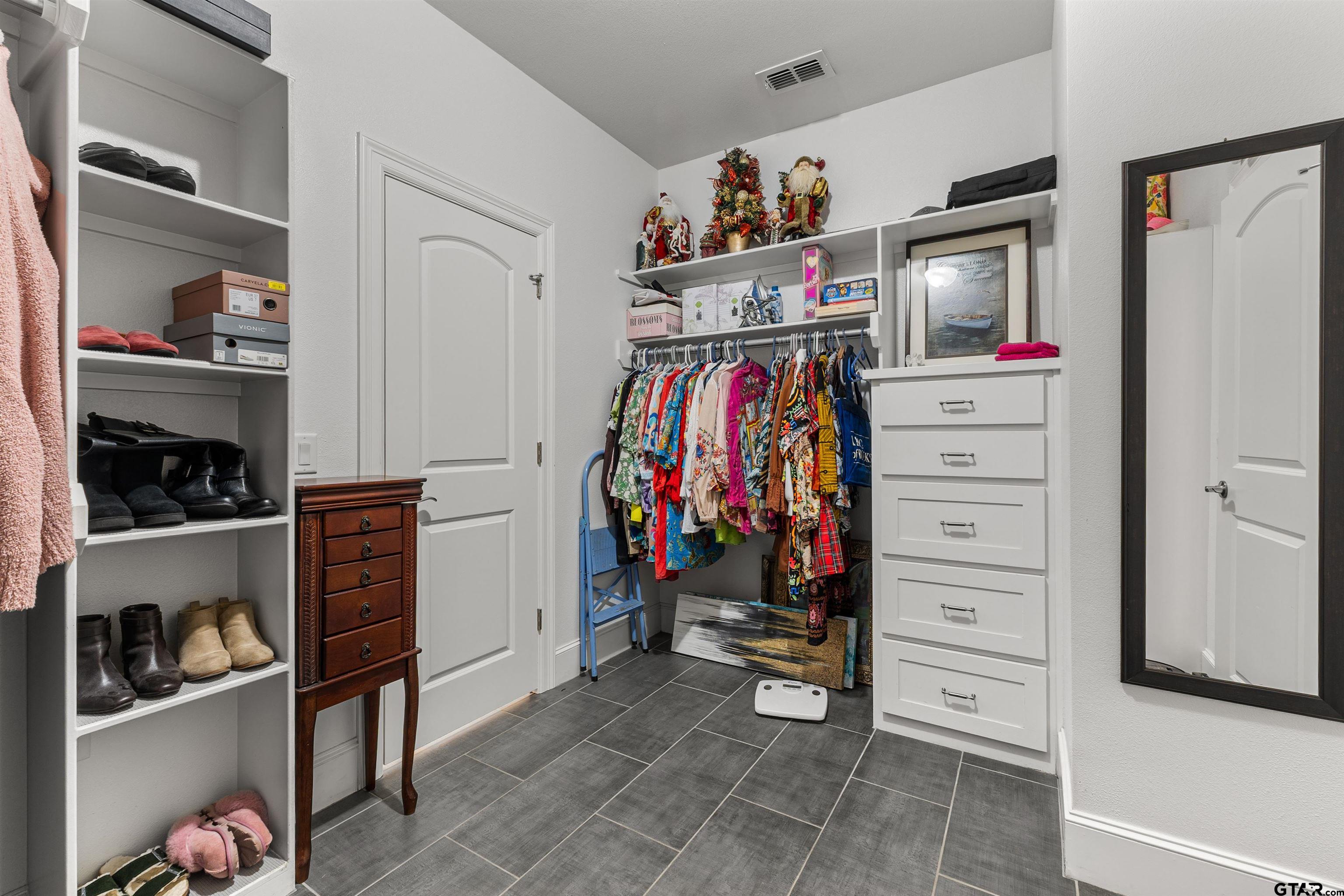 1111 Cambridge Bend Tyler, TX 75703 - Photo 34 of 42 a view of walk in closet with clothes and shoes