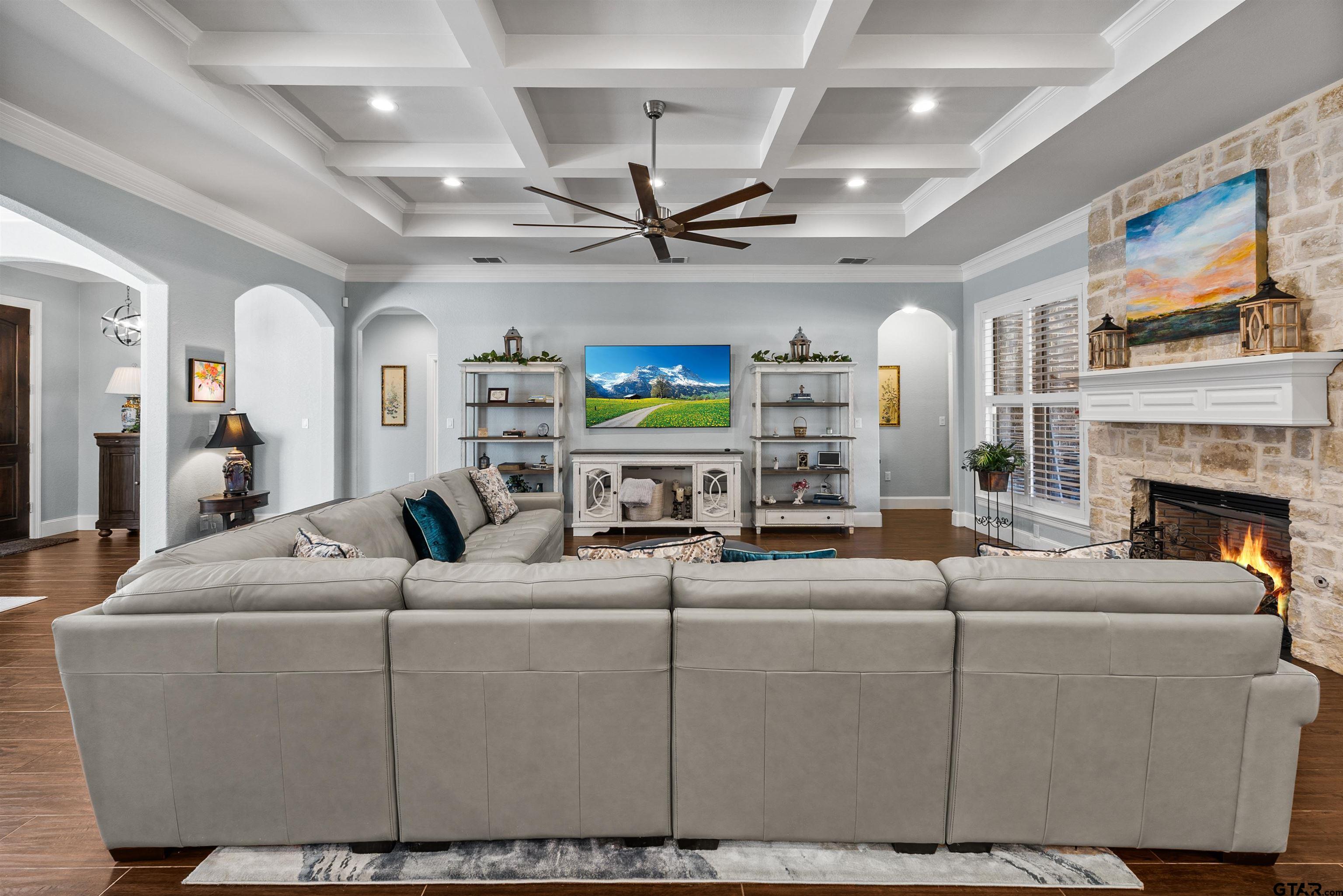 1111 Cambridge Bend Tyler, TX 75703 - Photo 7 of 42 a living room with fireplace furniture and a chandelier