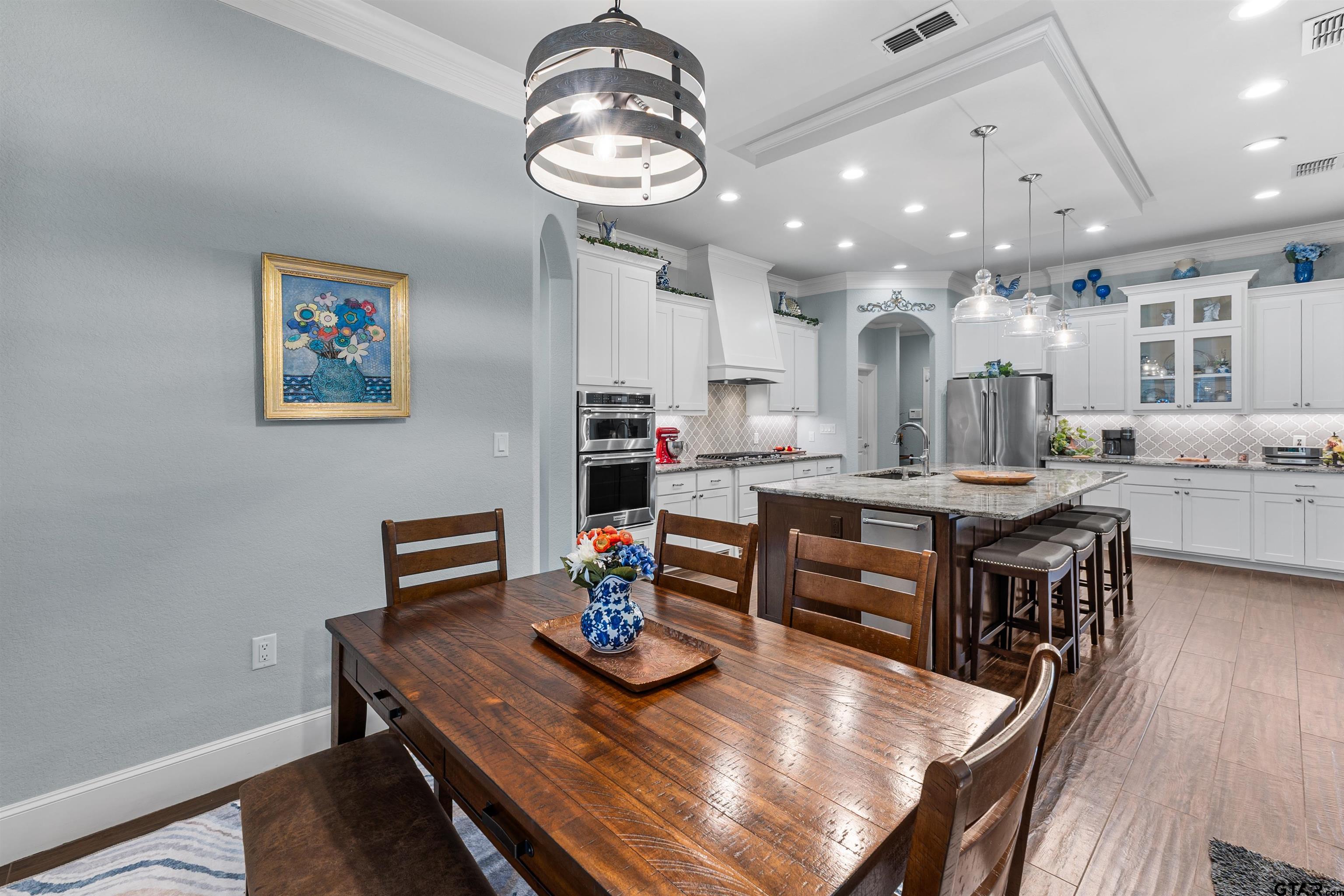 1111 Cambridge Bend Tyler, TX 75703 - Photo 10 of 42 a view of a dining room with furniture and wooden floor