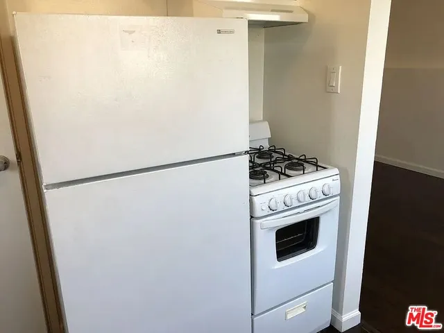 a kitchen with a refrigerator and a sink