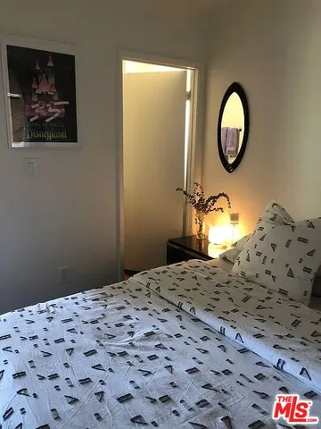 a kitchen with a stove and a wooden floor