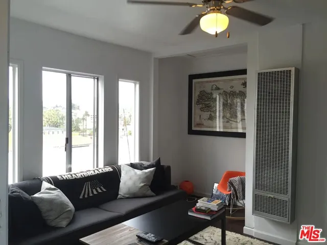 a view of a kitchen with a sink refrigerator and window