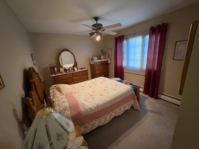 940 17th Street, Unit 7 Moline, IL 61265 - Photo 4 of 7 a bedroom with a bed and a dresser with mirror
