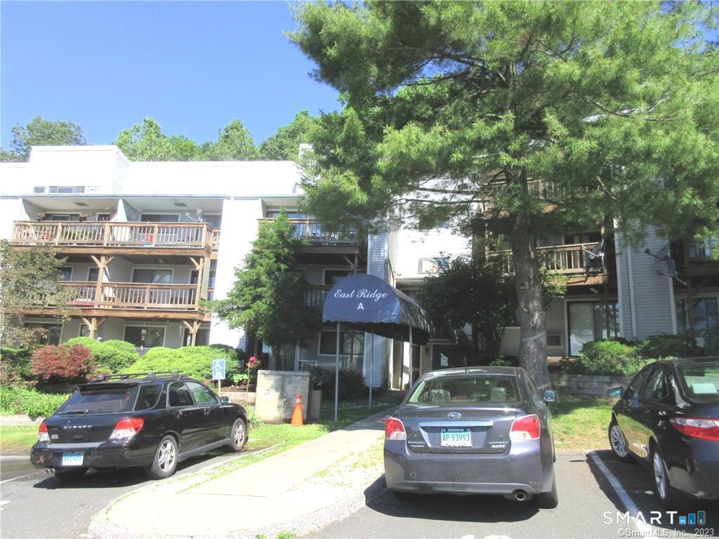 5 Nabby Road, Unit A17 Danbury, CT 06811 - Photo 1 of 11 a car parked in front of a building