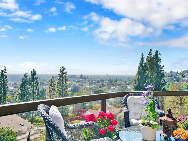 a living room with stainless steel appliances kitchen island granite countertop furniture and a large window