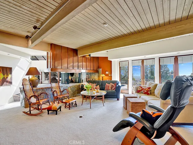 a view of a lake with couches and wooden fence