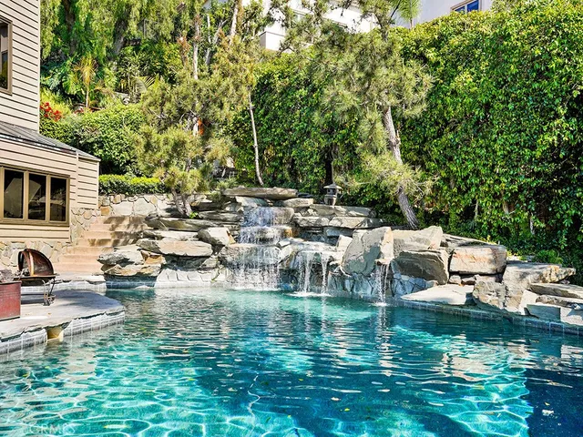 a bedroom with a bed a chair and a large window