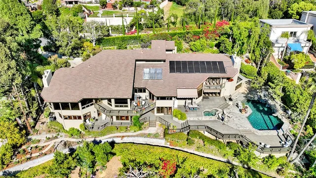 a living room with furniture a fireplace and a large window